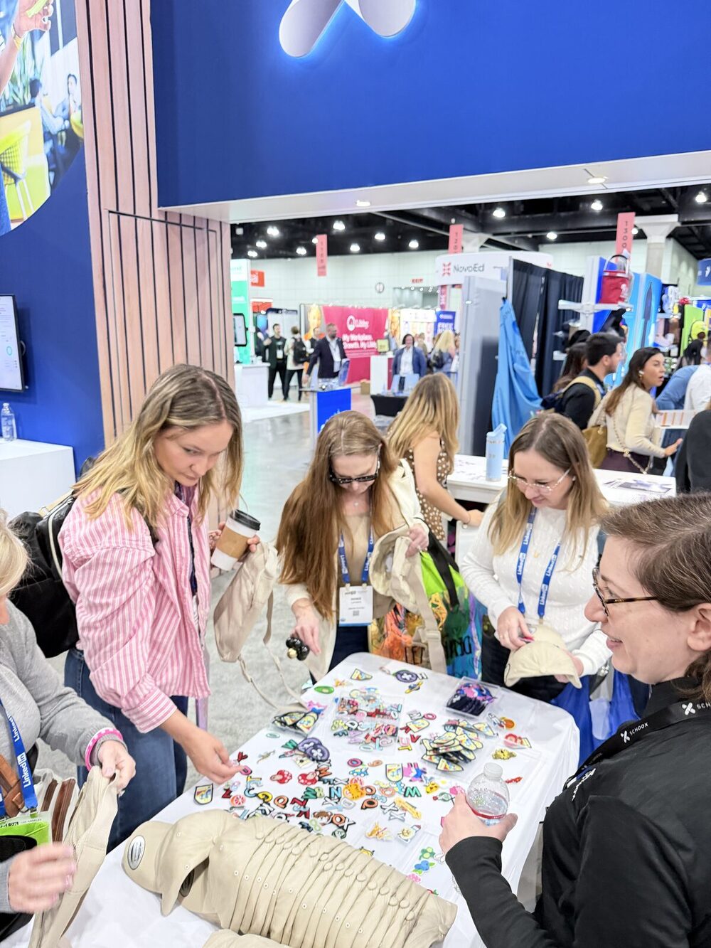 An elevated view of a live screen-printing activation drawing a crowd at a New York convention-style event